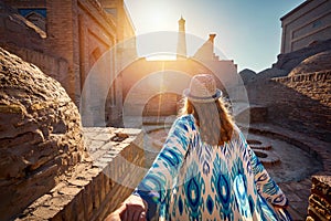 Woman tourist at old city Khiva in Uzbekistan