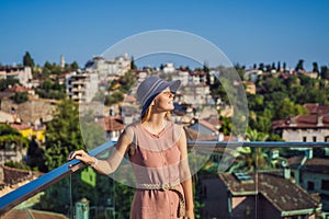 Woman tourist in Old town Kaleici in Antalya. Turkiye. Panoramic view of Antalya Old Town port, Taurus mountains and