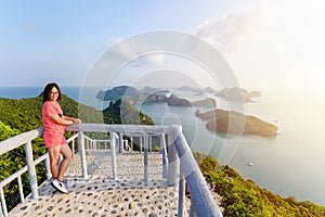 Woman tourist on peak viewpoint of island