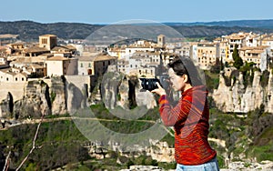 Woman tourist with photo camera, Cuenca, Spain