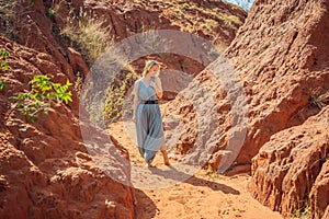 Woman tourist in red canyon, resumption of tourism concept