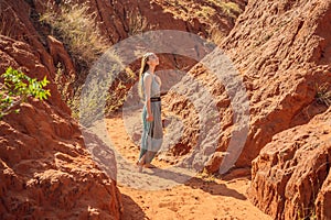 Woman tourist in red canyon, resumption of tourism concept