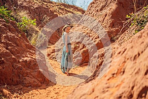 Woman tourist in red canyon, resumption of tourism concept