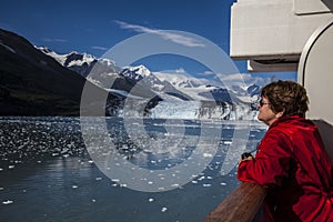 Woman tourist in red jacket on cruise ship