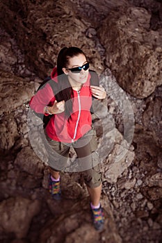 Woman tourist in the rocky grot. top view photo