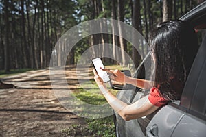 Woman tourist searching place from smartphone in car