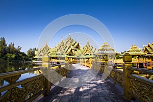 A woman tourist is sightseeing beautiful golden pavilion inside Ancient city Muang Boran