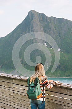 Woman tourist sightseeing looking at view in Norway solo travel backpacking photo