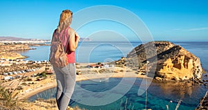 Woman tourist in Spain looking at beautiful panoramic beach