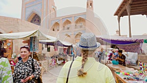 Woman tourist at street market in Ichan Kala of Khiva