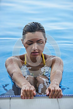 Woman tourist swimming in infinity pool
