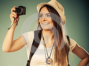 Woman tourist taking photo with camera