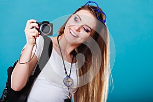 Woman tourist taking photo with camera