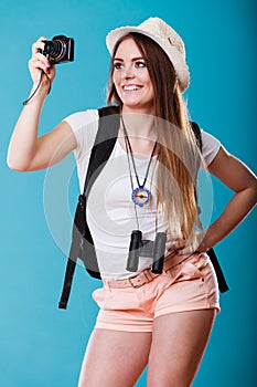 Woman tourist taking photo with camera