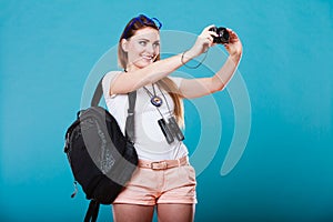 Woman tourist taking photo with camera