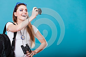 Woman tourist taking photo with camera