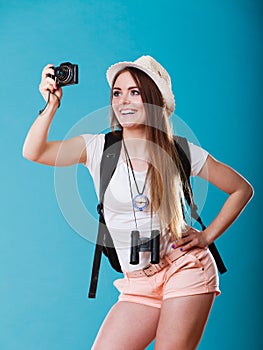 Woman tourist taking photo with camera