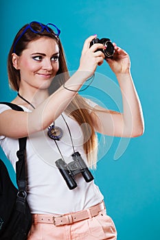 Woman tourist taking photo with camera