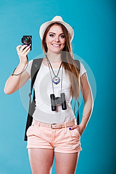 Woman tourist taking photo with camera