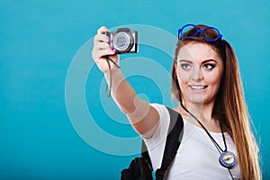 Woman tourist taking photo with camera