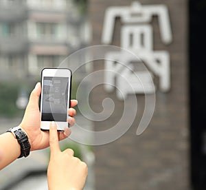 Woman tourist taking photo with cellphone on street