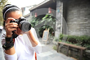 Woman tourist taking photo on street