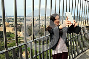 Woman tourist taking selfie from the top of the San Pietro Dome