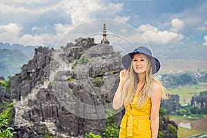 Woman tourist on top pagoda of Hang Mua temple, rice fields, Ninh Binh, Vietnam. Vietnam reopens borders after