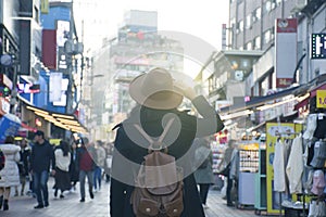 Woman tourist is traveling into Hongdae fashion street market in Seoul, Korea.