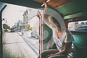 Woman tourist traveling to the Thai public transport, Songteo