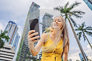 Woman Tourist using navigation app on the mobile phone. Navigation map on a smartphone in a big city