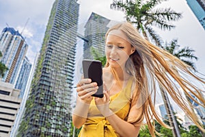 Woman Tourist using navigation app on the mobile phone. Navigation map on a smartphone in a big city