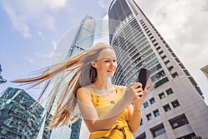 Woman Tourist using navigation app on the mobile phone. Navigation map on a smartphone in a big city