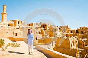 Woman tourist on viewpoint sightseeing Kharanaq, traditional and historic village in Iran