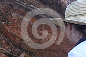 Woman tourist visit at Ubirr rock art site in Kakadu National Park Northern Territory of Austr