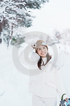 Woman tourist Visiting in Asahikawa, Traveler in Sweater sightseeing Asahiyama Zoo with Snow in winter season. landmark and