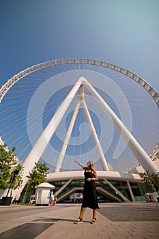 Woman tourist visits Ain Eye DUBAI - One of the largest Ferris Wheels in the World, located on Bluewaters island. Top tourists