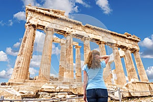 Woman tourist visits temple of Parthenon on Acropolis, Athens, Greece