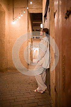 Woman tourist walking in Al Seef Meraas Dubai - old historical district with traditional Arabic architecture