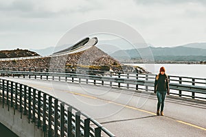 Woman tourist walking alone at Atlantic road in Norway