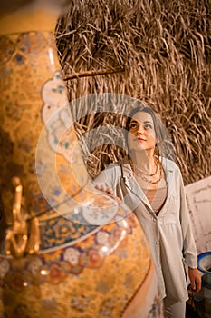 Woman tourist walking in Arab market near Al Seef with crockery, lamps and lanterns in the old style