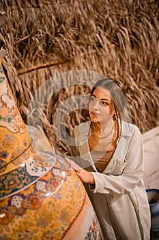 Woman tourist walking in Arab market near Al Seef with crockery, lamps and lanterns in the old style