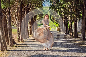 Woman tourist walking in Montenegro. Panoramic summer landscape of the beautiful green Royal park Milocer on the shore