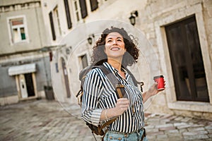 Woman tourist walking on the street in european old city