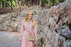 Woman tourist walking together in Montenegro. Panoramic summer landscape of the beautiful green Royal park Milocer on