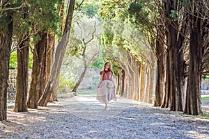 Woman tourist walking together in Montenegro. Panoramic summer landscape of the beautiful green Royal park Milocer on