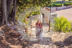 Woman tourist walking together in Montenegro. Panoramic summer landscape of the beautiful green Royal park Milocer on