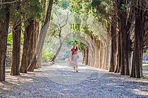 Woman tourist walking together in Montenegro. Panoramic summer landscape of the beautiful green Royal park Milocer on