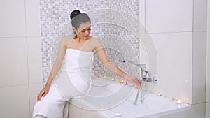 Woman with towel on bathtub