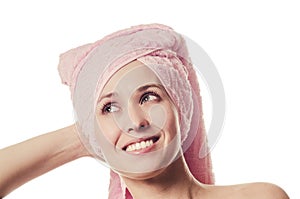 The woman with a towel on the head smiles with teeth